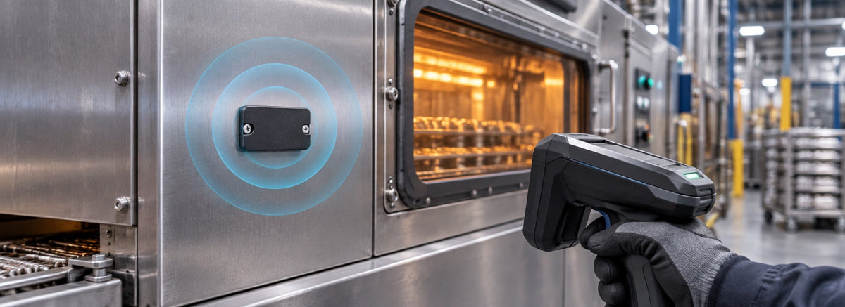 Black industrial UHF tag mounted on the exterior of a thermal processing machine and scanned with a handheld reader.